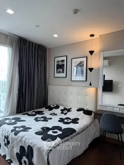 Modern bedroom with stylish decor and city view, featuring a cozy bed and elegant lighting.