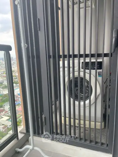 Compact balcony with washing machine and city view, ideal for urban living convenience.