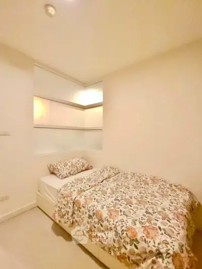 Cozy bedroom with floral bedding and modern design in a stylish apartment.