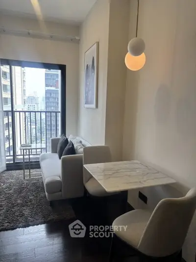 Chic modern living room with city view, featuring cozy seating and elegant marble dining table.