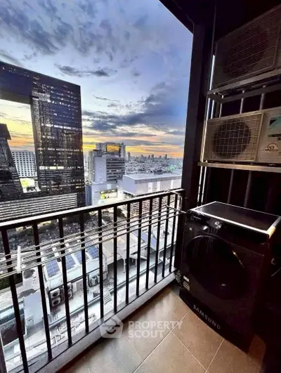 Stunning city view from a high-rise balcony with modern appliances, perfect for urban living.