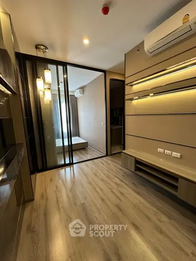 Modern living room with sleek design and wooden flooring in a stylish apartment