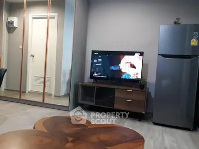 Modern living room with sleek furniture and large fridge, perfect for contemporary urban living.