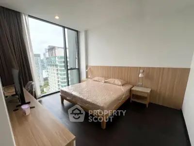 Modern bedroom with large window offering city views, featuring sleek wooden furniture and minimalist design.
