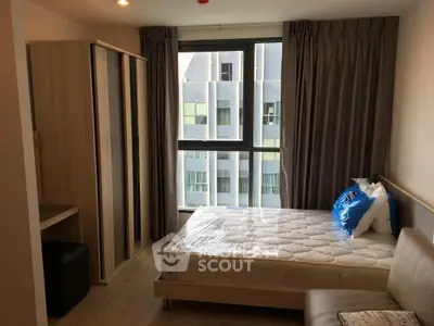 Modern bedroom with large window and stylish furniture in urban apartment