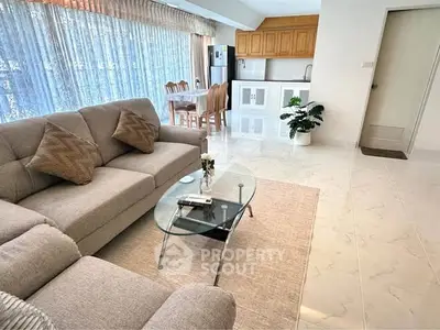 Spacious living room with modern furniture and open kitchen layout