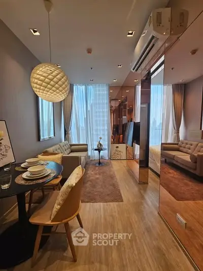 Modern living room with dining area and stylish decor in a cozy apartment.