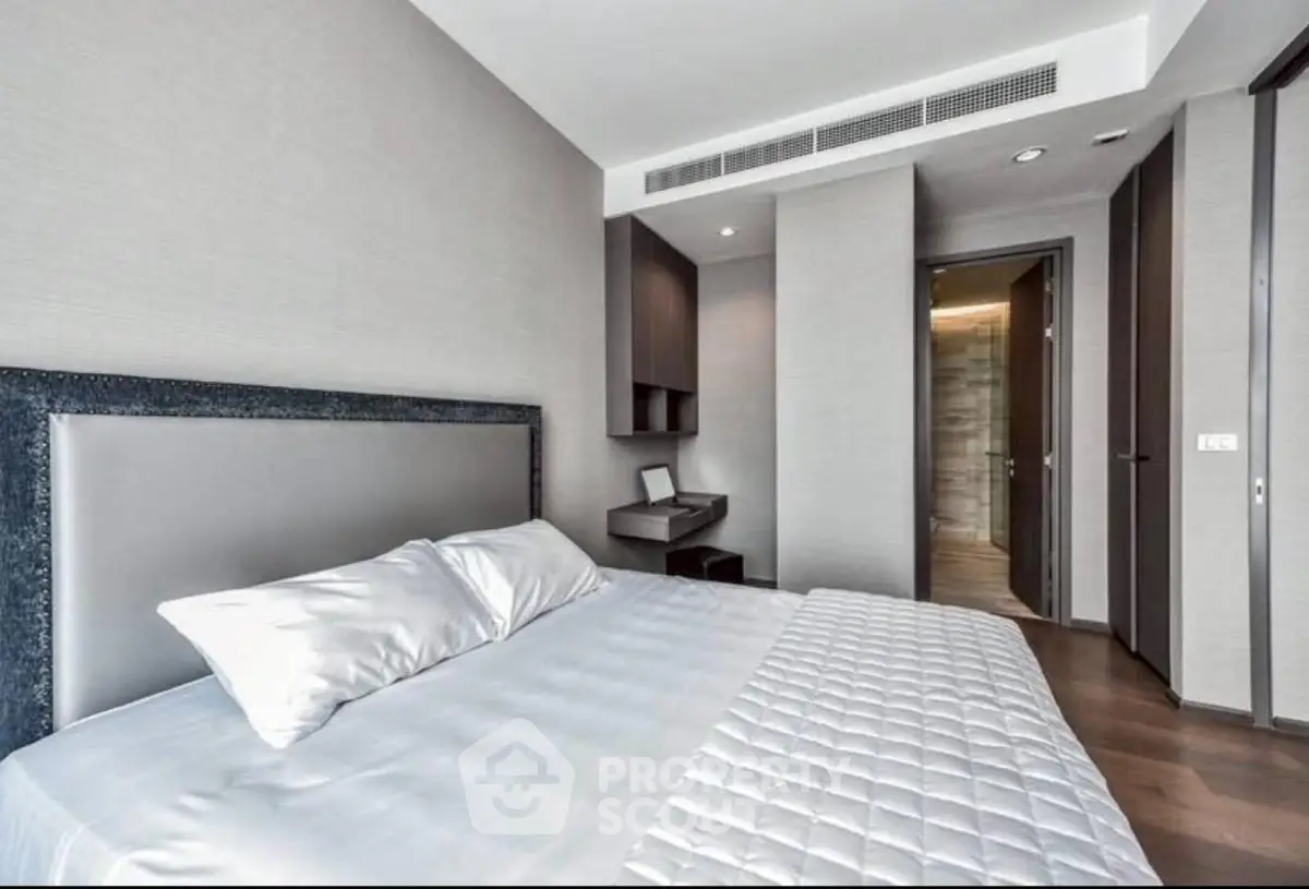 Modern bedroom with sleek design and neutral tones, featuring a comfortable bed and stylish decor.