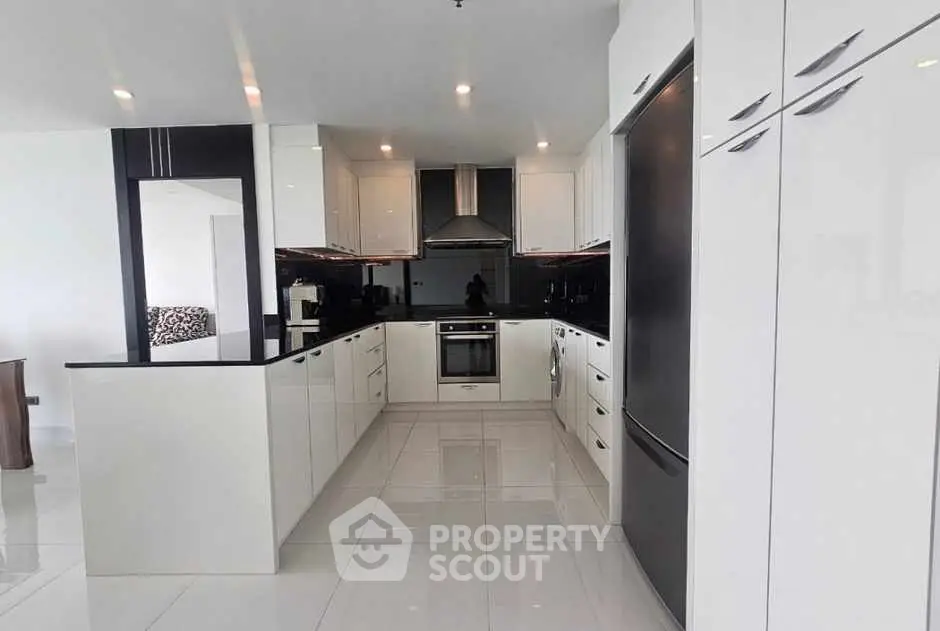 Modern kitchen with sleek white cabinetry and stainless steel appliances