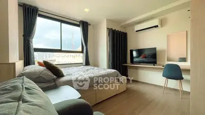 Modern bedroom with large window and stylish furnishings