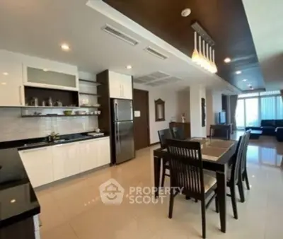 Spacious open-layout kitchen and dining area with modern furnishings and ample natural light.