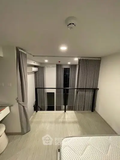 Modern loft bedroom with minimalist design and large windows