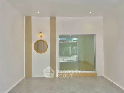 Minimalist interior with sliding glass door and decorative wall feature in modern home.