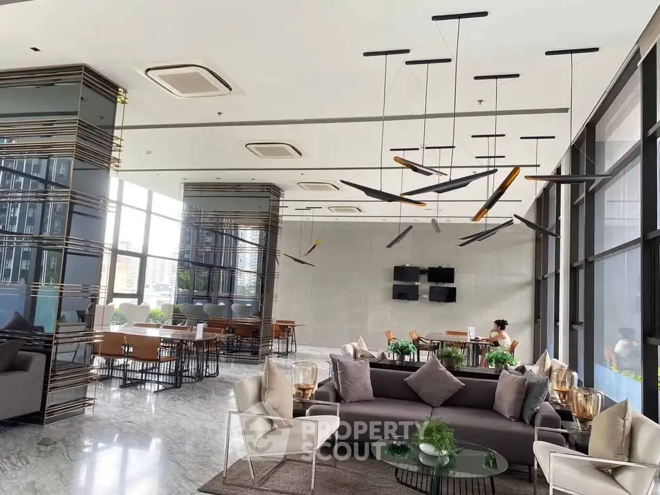 Luxurious modern lobby with stylish seating and contemporary lighting in a high-end building.