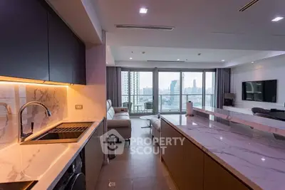Luxurious open-plan kitchen and living room with stunning city view and modern marble countertops.