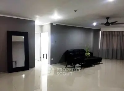 Spacious modern living room with sleek black furniture and elegant decor