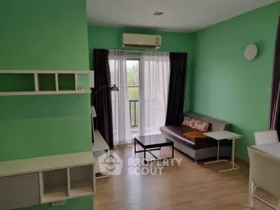 Modern living room with green walls, cozy sofa, and balcony view