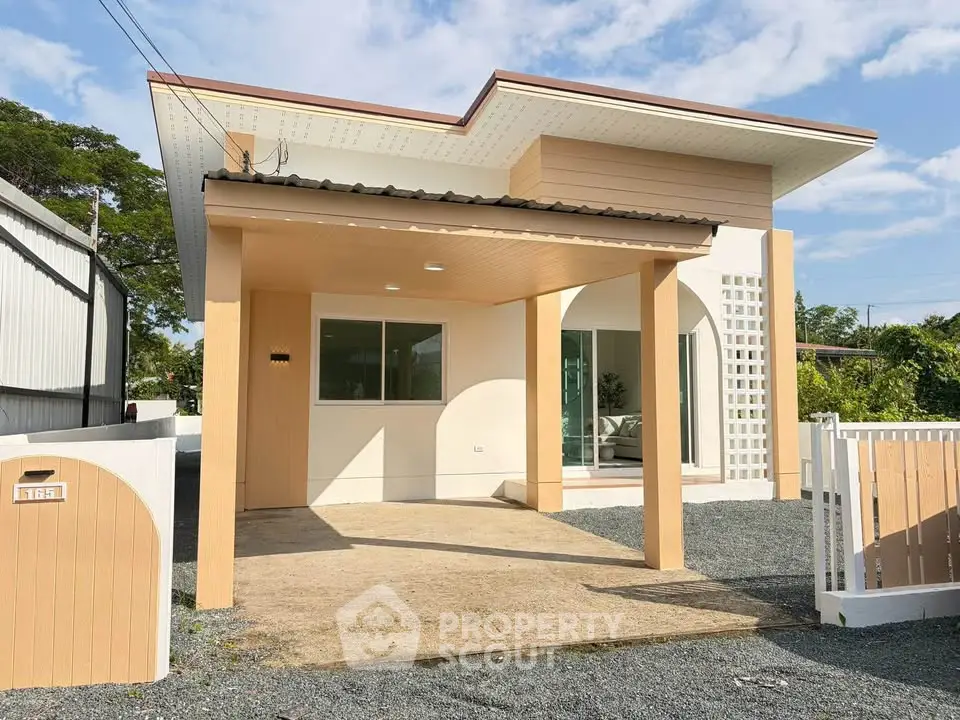Modern single-story house with unique roof design and spacious driveway.