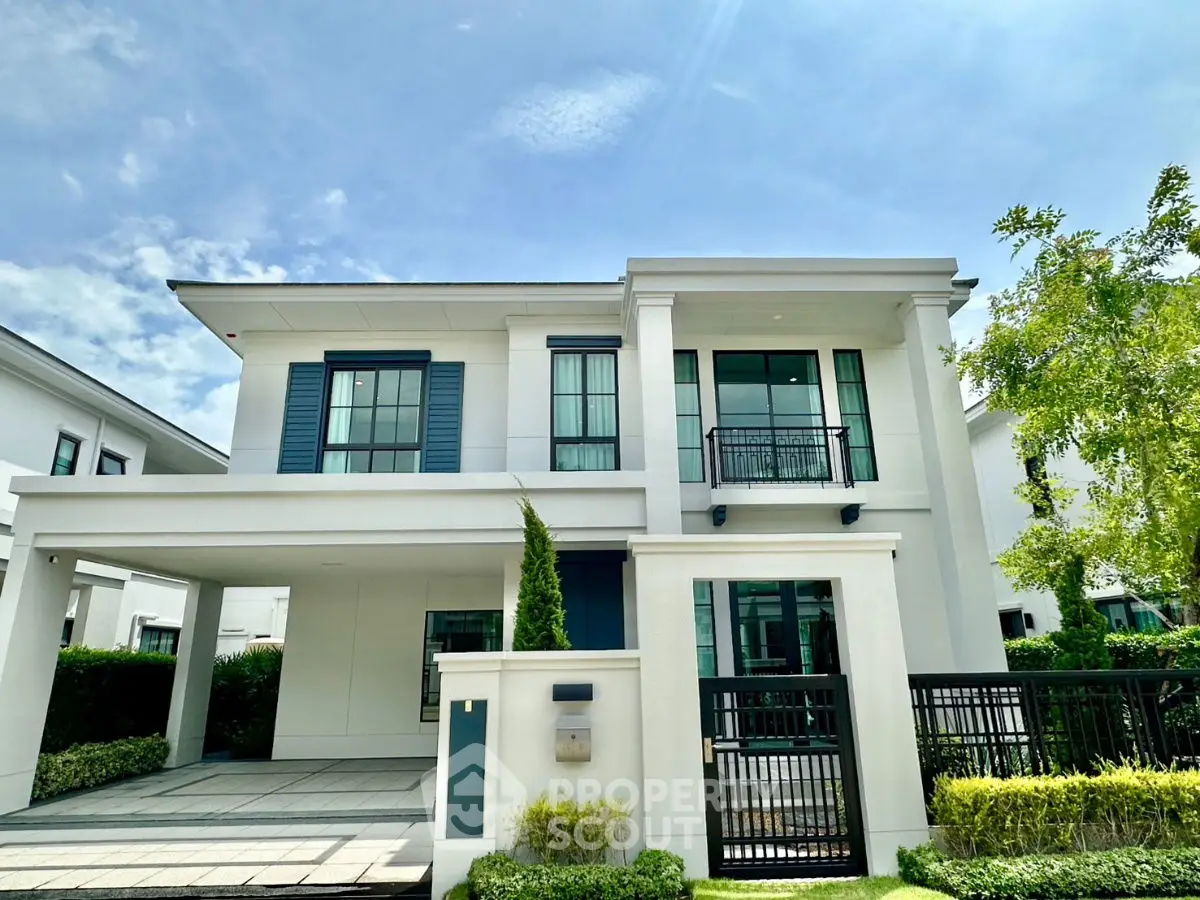 Stunning modern two-story house with sleek design and lush greenery, perfect for luxurious living.