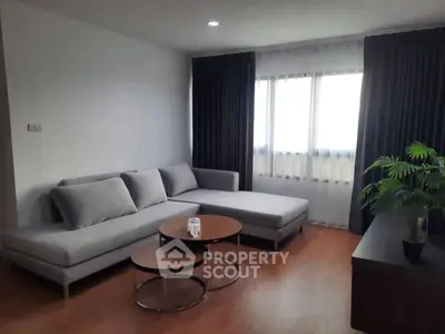 Modern living room with sleek gray sofa and stylish coffee tables