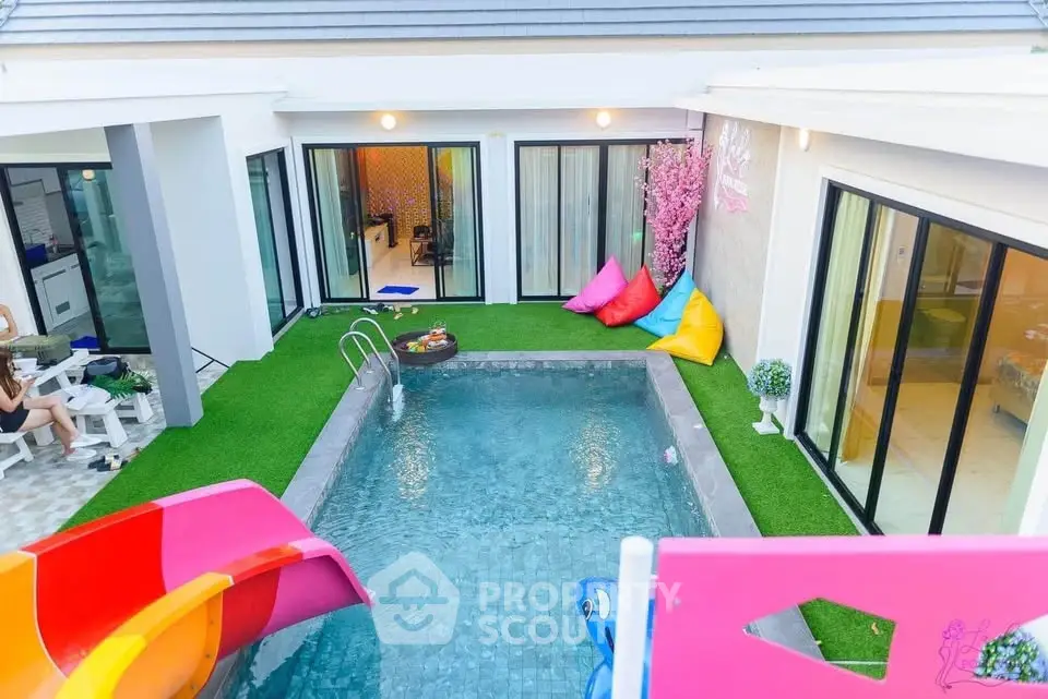 Luxurious modern villa with private pool and vibrant outdoor seating area, perfect for relaxation and entertainment.