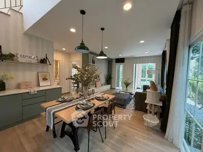 Stylish open-plan living and dining area with modern decor and large windows.