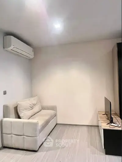 Cozy living room with modern sofa and air conditioning