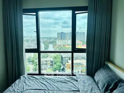 Modern bedroom with large window offering stunning city view