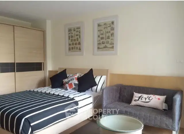 Modern bedroom with stylish decor and cozy seating area, perfect for relaxation.