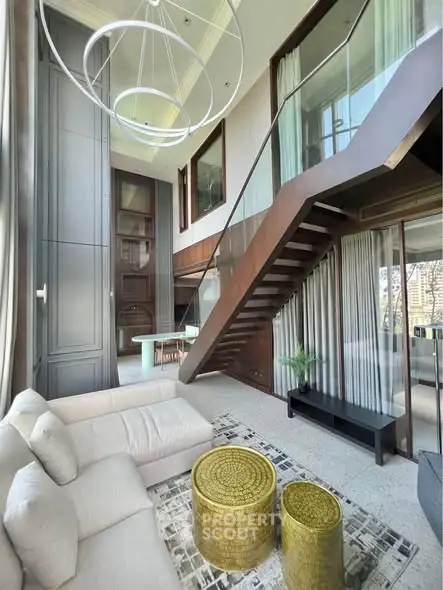 Luxurious modern living room with high ceilings and stylish staircase