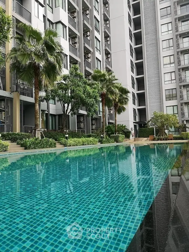Luxurious condominium with stunning pool and lush greenery, perfect for modern living.