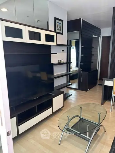 Modern living room with sleek furniture and glass coffee table in stylish apartment.