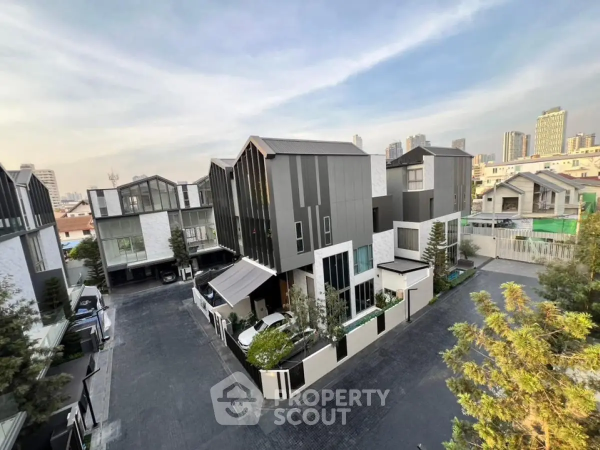 Modern townhouse complex with sleek design and city skyline view