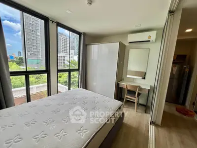Modern bedroom with large windows and city view, featuring a cozy bed, wardrobe, and study desk.