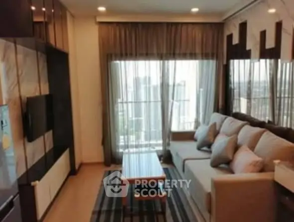 Modern living room with city view, cozy sofa, and stylish decor.