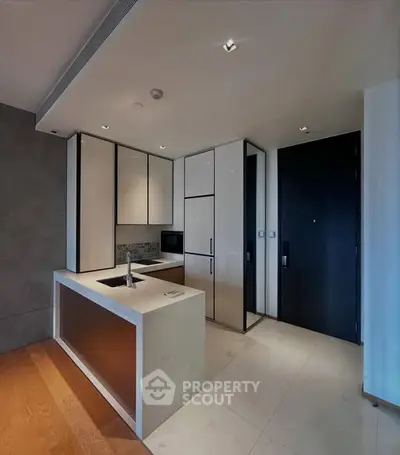 Modern kitchen with sleek design and open layout, featuring built-in appliances and stylish cabinetry.