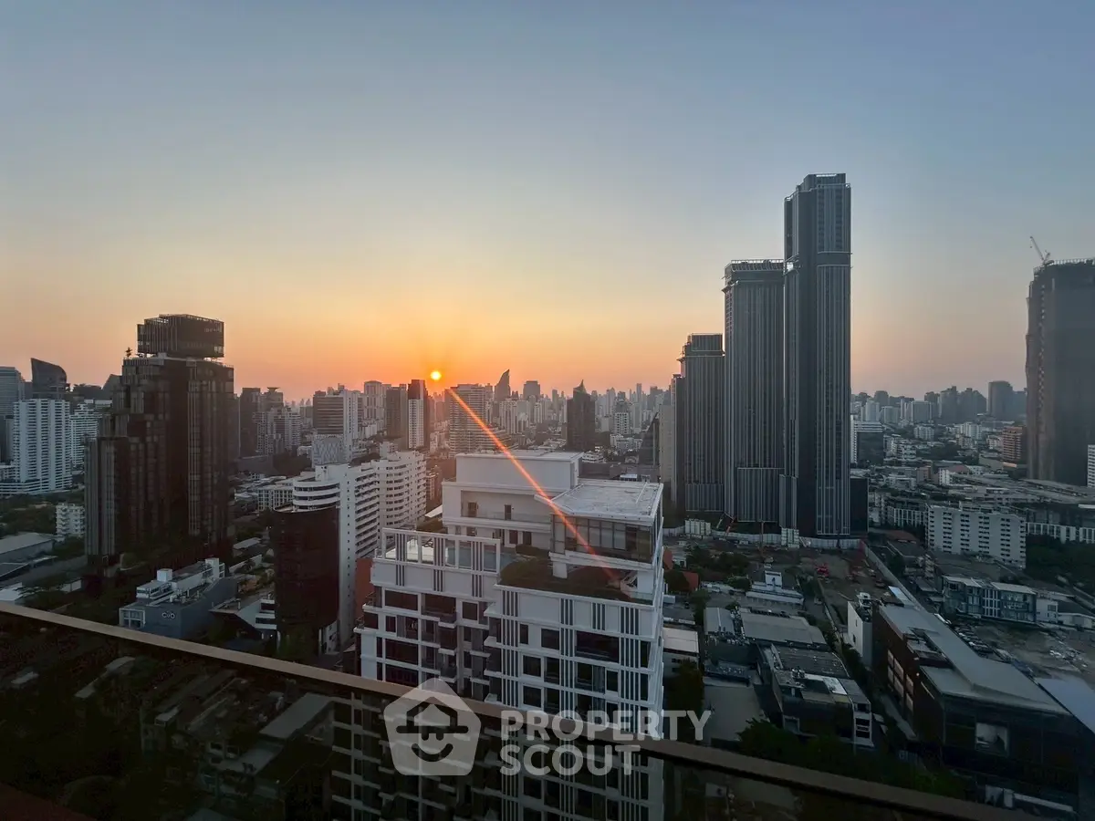 Stunning urban skyline view at sunset from a high-rise balcony.