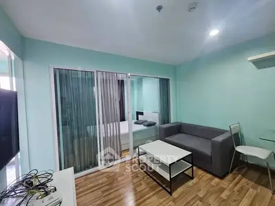 Modern living room with sleek furniture and wooden flooring in a stylish apartment.