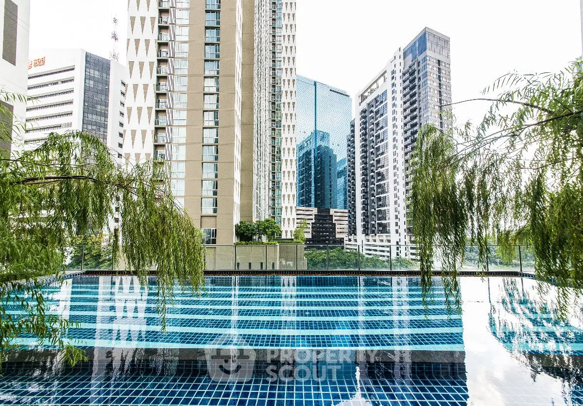 Luxurious urban high-rise buildings with a stunning rooftop pool and lush greenery.