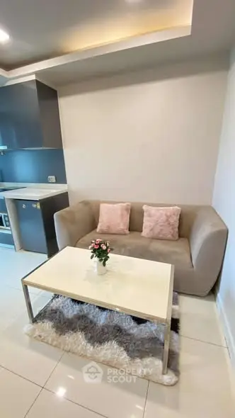 Modern living room with cozy sofa and sleek kitchen area