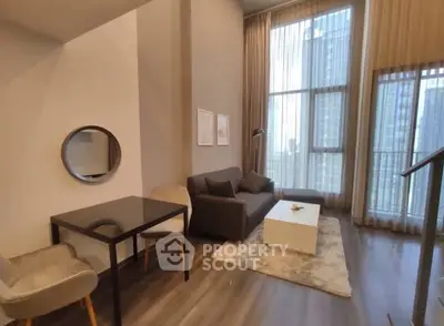 Modern living room with high ceilings and large windows in urban apartment