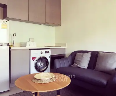 Modern compact living room with washing machine and cozy sofa