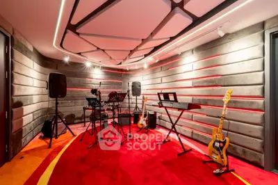 Luxurious home music studio with modern acoustic design and vibrant red carpet, perfect for musicians.