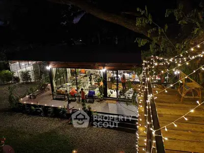 Charming modern home with outdoor deck and ambient lighting at night.