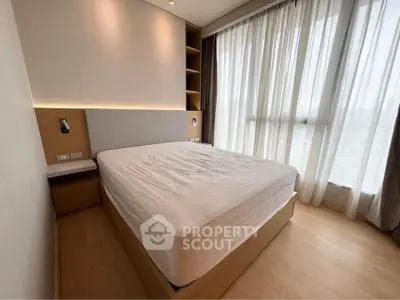 Modern bedroom with large windows and natural light in a stylish apartment.