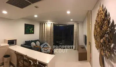 Modern living room with stylish decor and balcony access in a contemporary apartment.