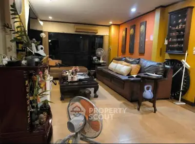 Spacious living room with cozy seating and elegant decor, perfect for relaxation and entertainment.