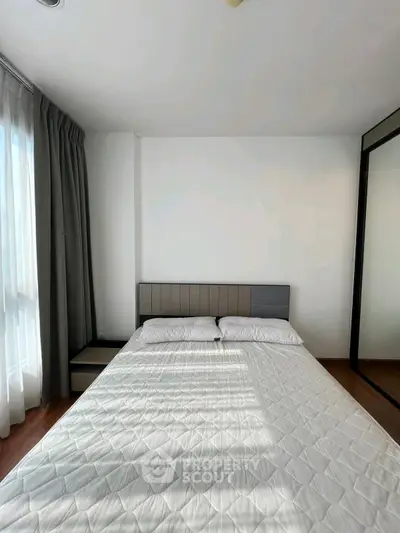 Modern bedroom with large window and stylish decor
