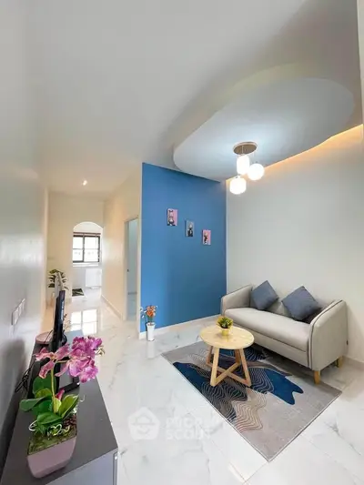 Modern living room with stylish decor and blue accent wall