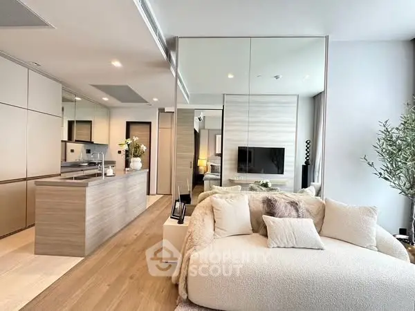 Modern open-plan living room with cozy seating and sleek kitchen design